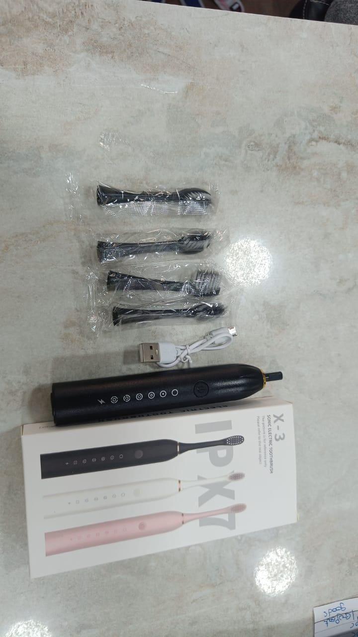 Sonin electric toothbrush with sleek handle and bristle head, rechargeable battery, and ergonomic design for effective cleaning.