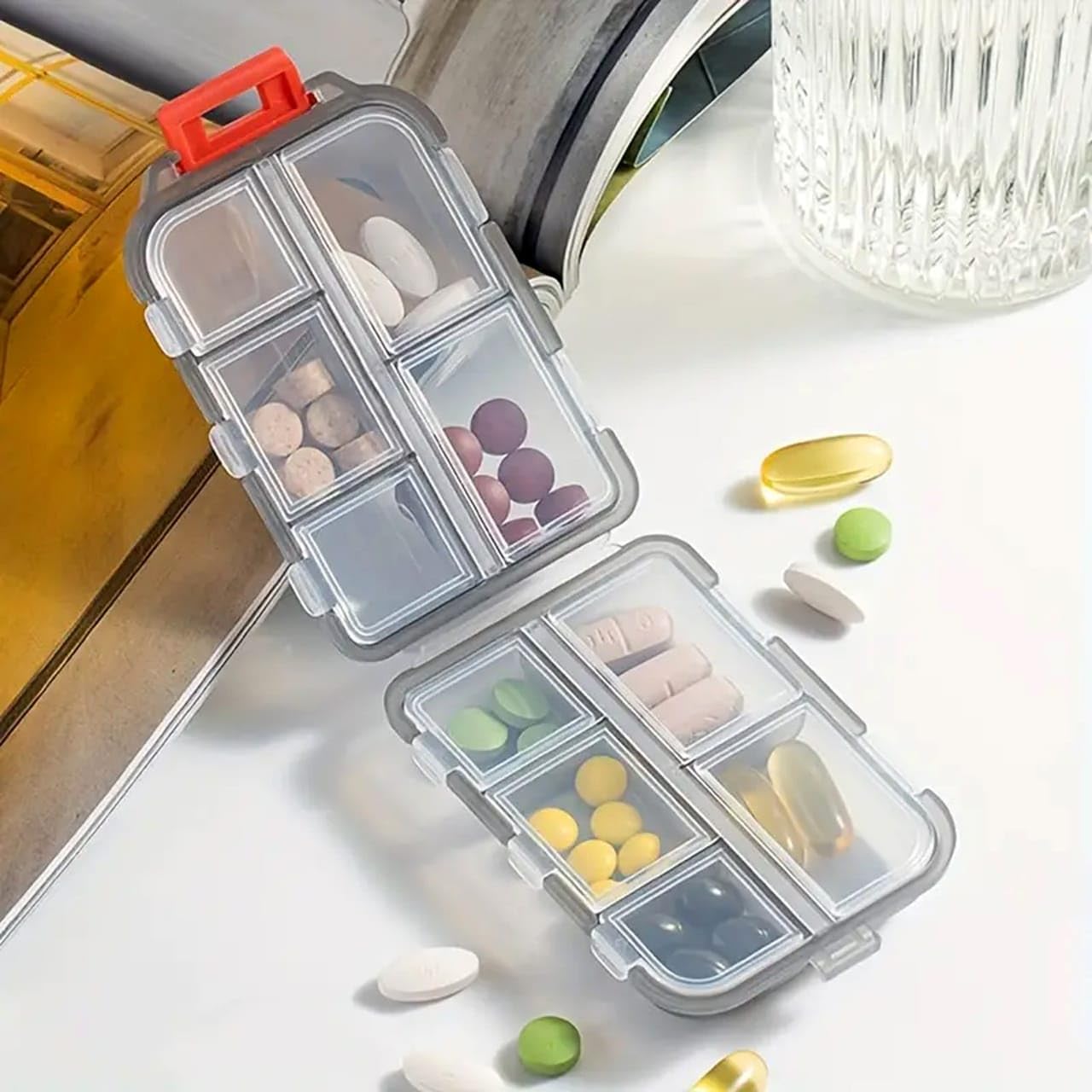 Double layer pill organizer from Drpshippr with multiple compartments for medication storage, in a compact kitchen or home setting.