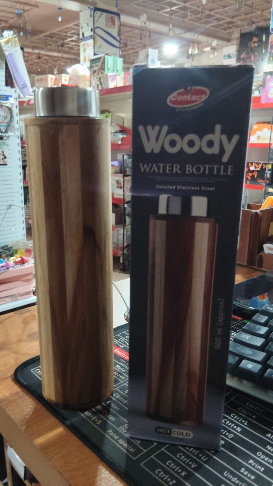 B Grade wooden water bottle by Wukusy featuring a smooth, polished wooden surface and a secure cap in a natural setting