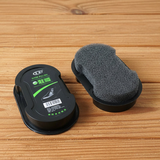 Wukusy instant shoe polish sponge applicator for leather shoes, showing the compact black sponge tool on a shoe surface