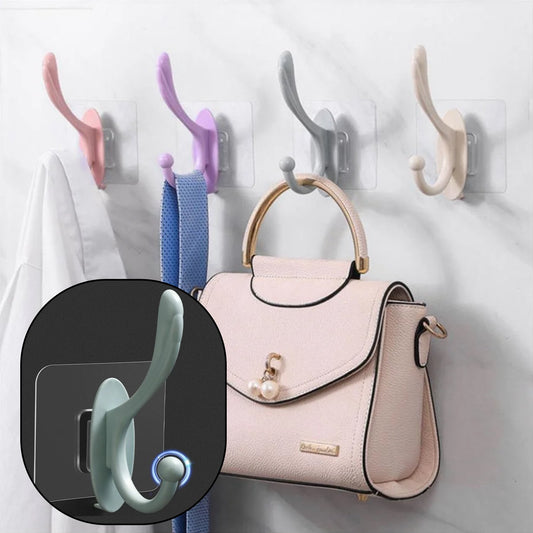 Wukusy 4687 self-adhesive plastic wall hook attached to a wall, ideal for home organization and hanging lightweight items