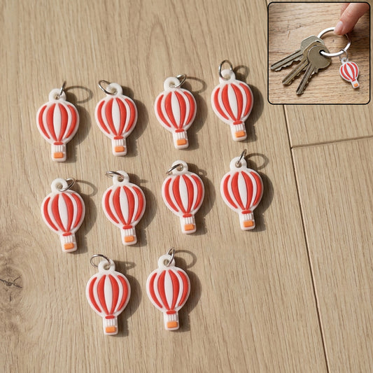 Set of 10 Wukusy hot air balloon bag charm keychains featuring colorful miniature hot air balloon designs.