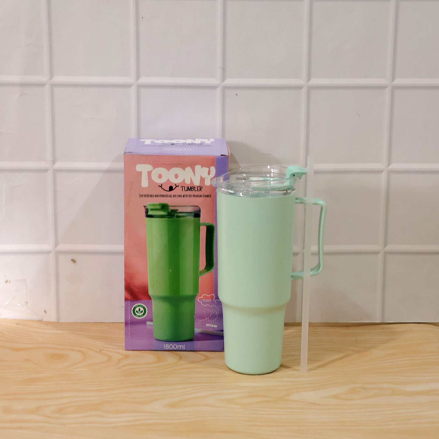 Wukusy Toony Tumbler 1800ml plastic travel sipper with handle, straw, and lid, shown with a colorful cartoon design.