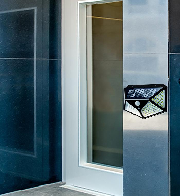 Wukusy 1255 solar garden LED security lamp illuminating outdoor pathways and home exterior at night.