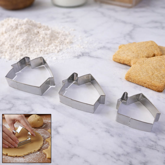 Stainless steel Wukusy house-shaped cookie cutter set with three mix design shapes on a baking surface.