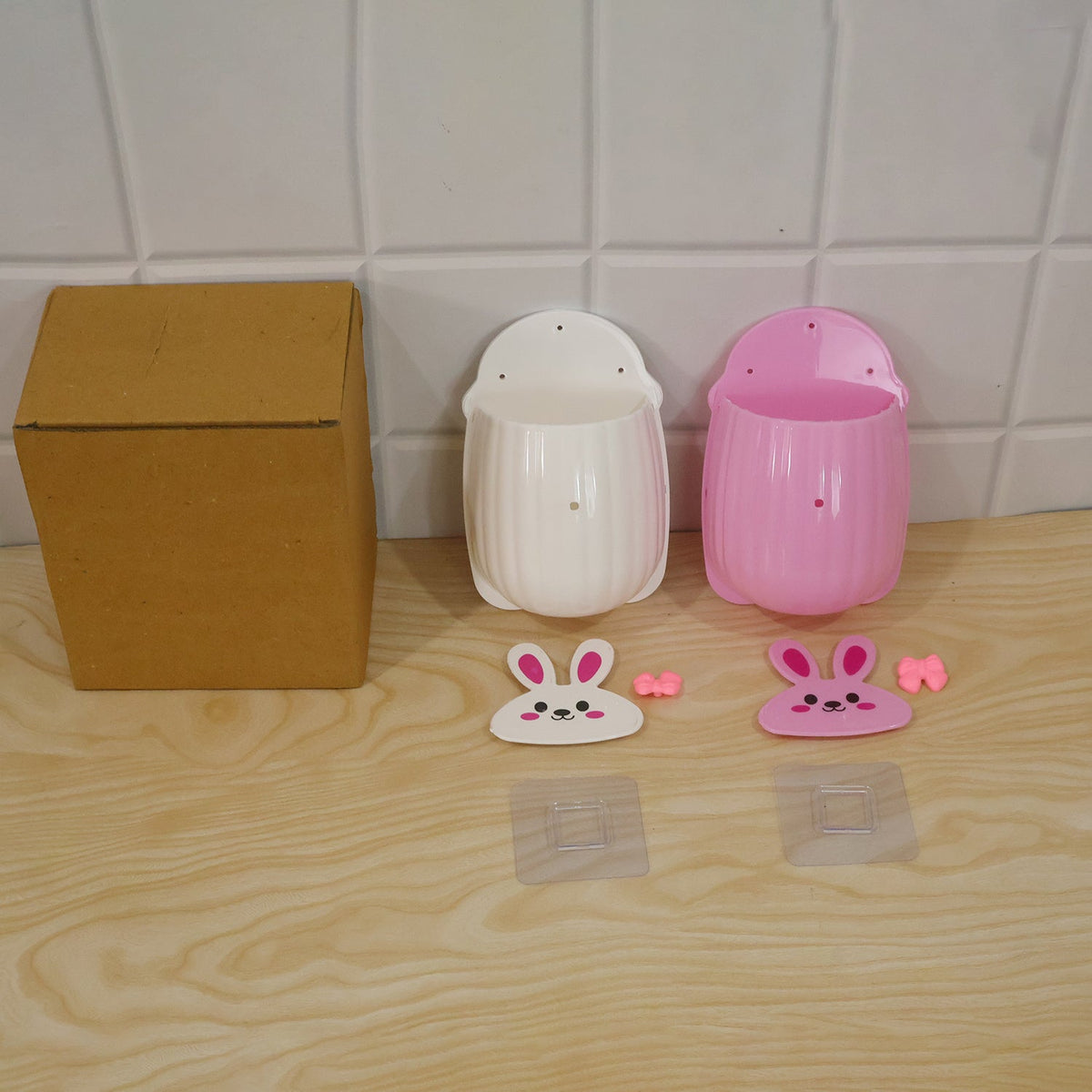 Wukusy rabbit design wall-mounted toothbrush holder set with two pieces for bathroom storage, featuring playful rabbit motifs.