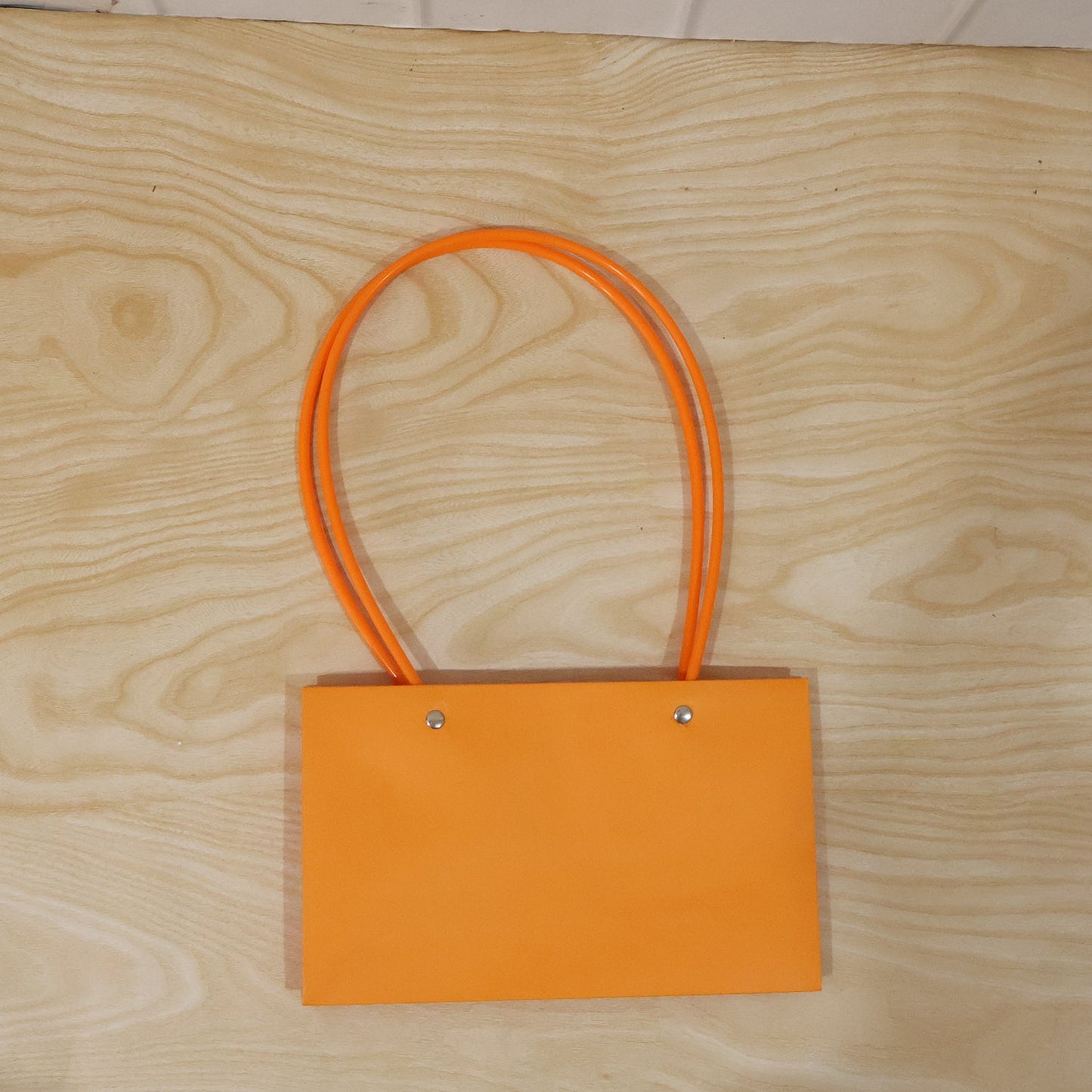 Foldable flower packaging bag with handle by Wukusy, designed for bouquets and gift presentation, shown in the image.