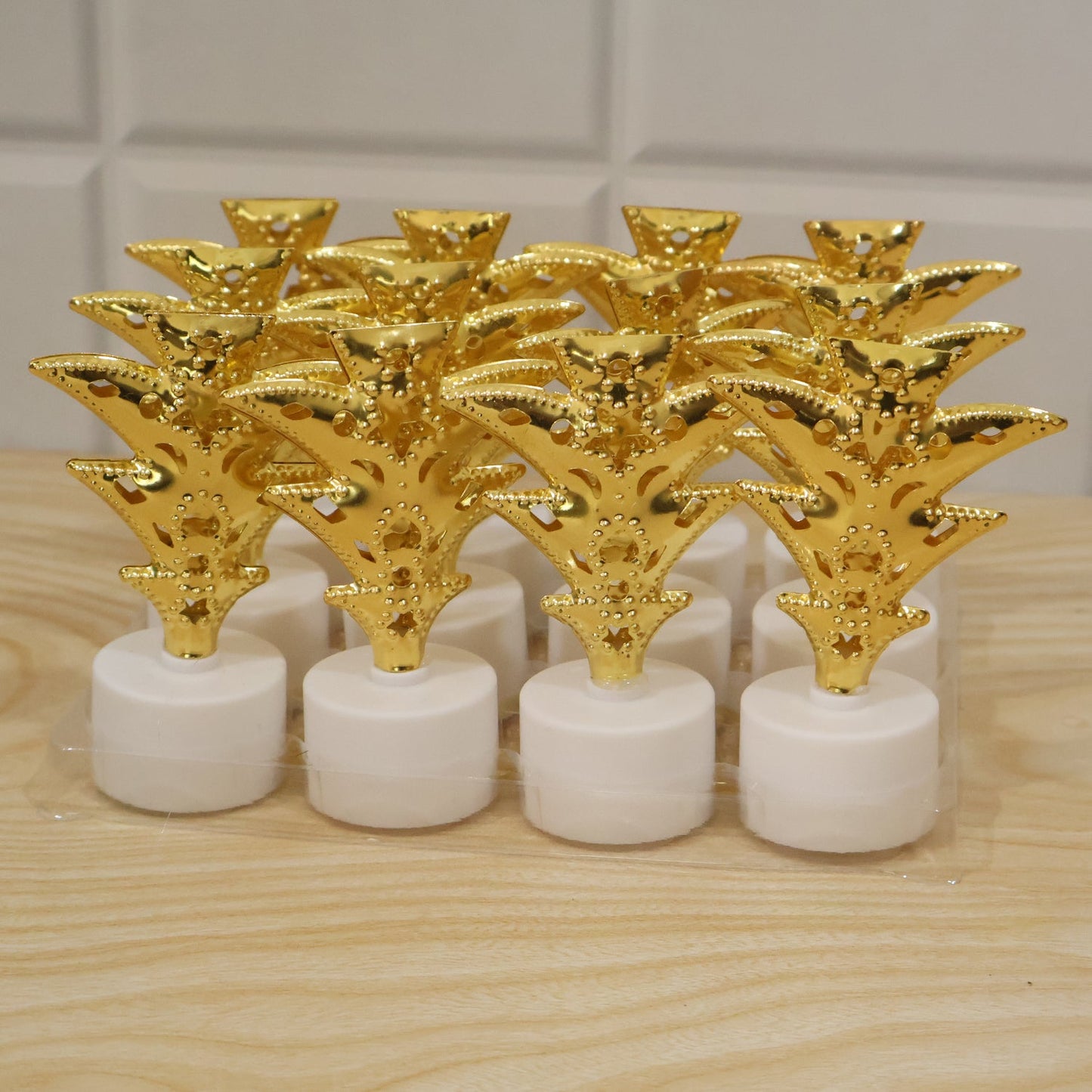 Set of 12 golden Christmas tree LED tealight candles by Wukusy, ideal for home and festive holiday decor.