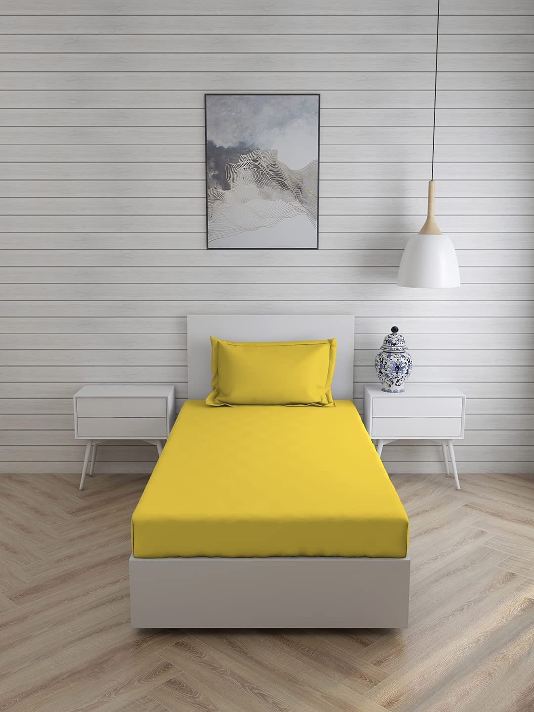 Yellow FIZZI SHOP plain bedsheet for single bed with matching pillow cover, soft cotton fabric, simple and comfortable bedroom decor.