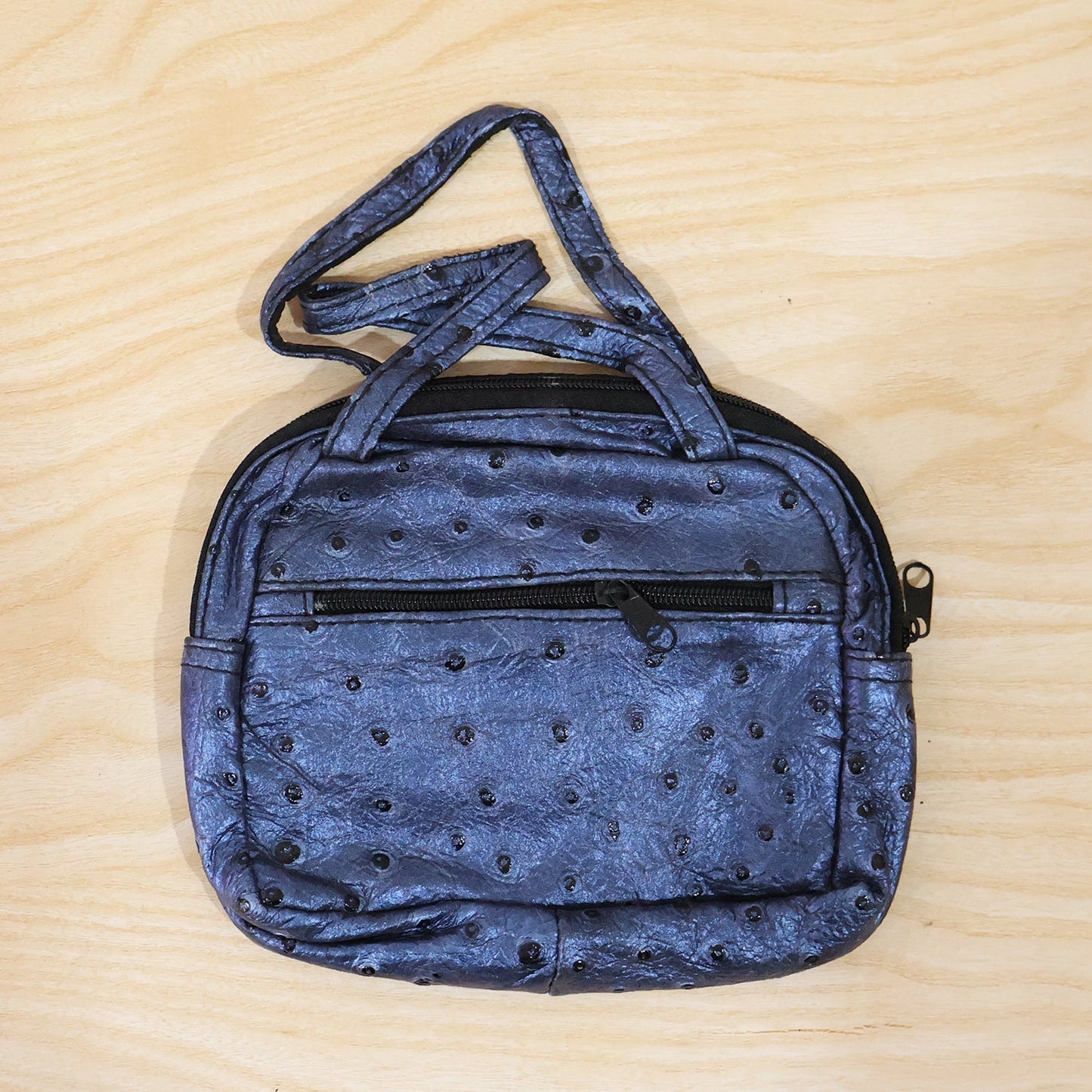 Metallic blue mini zipper handbag with ostrich pattern for women by Wukusy, showing the textured surface and compact design.
