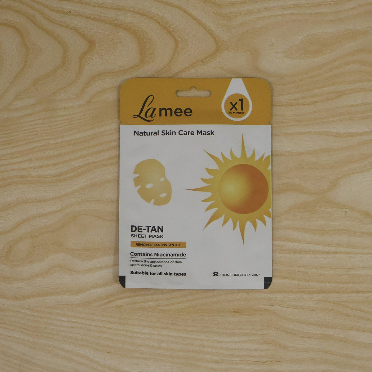 Wukusy De Tan facial sheet mask with niacinamide for hydrating skin care, shown on a flat surface with packaging.