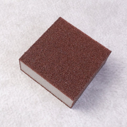 Wukusy multipurpose kitchen cleaning sponge scrub block, 7x7 cm, used for cleaning dishes, countertops, and kitchen surfaces.