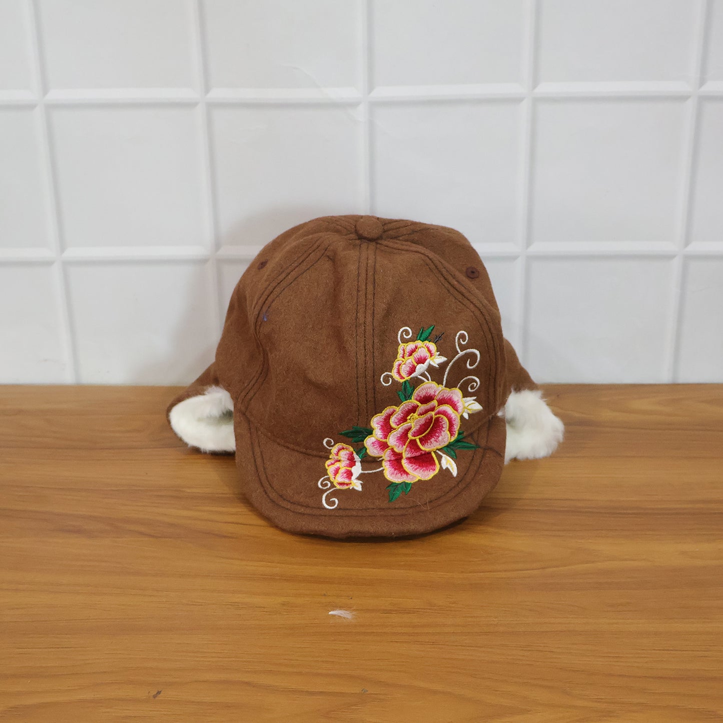 Wukusy premium winter ear flap cap for women, featuring warm ear flaps and cozy knit design for cold weather protection.