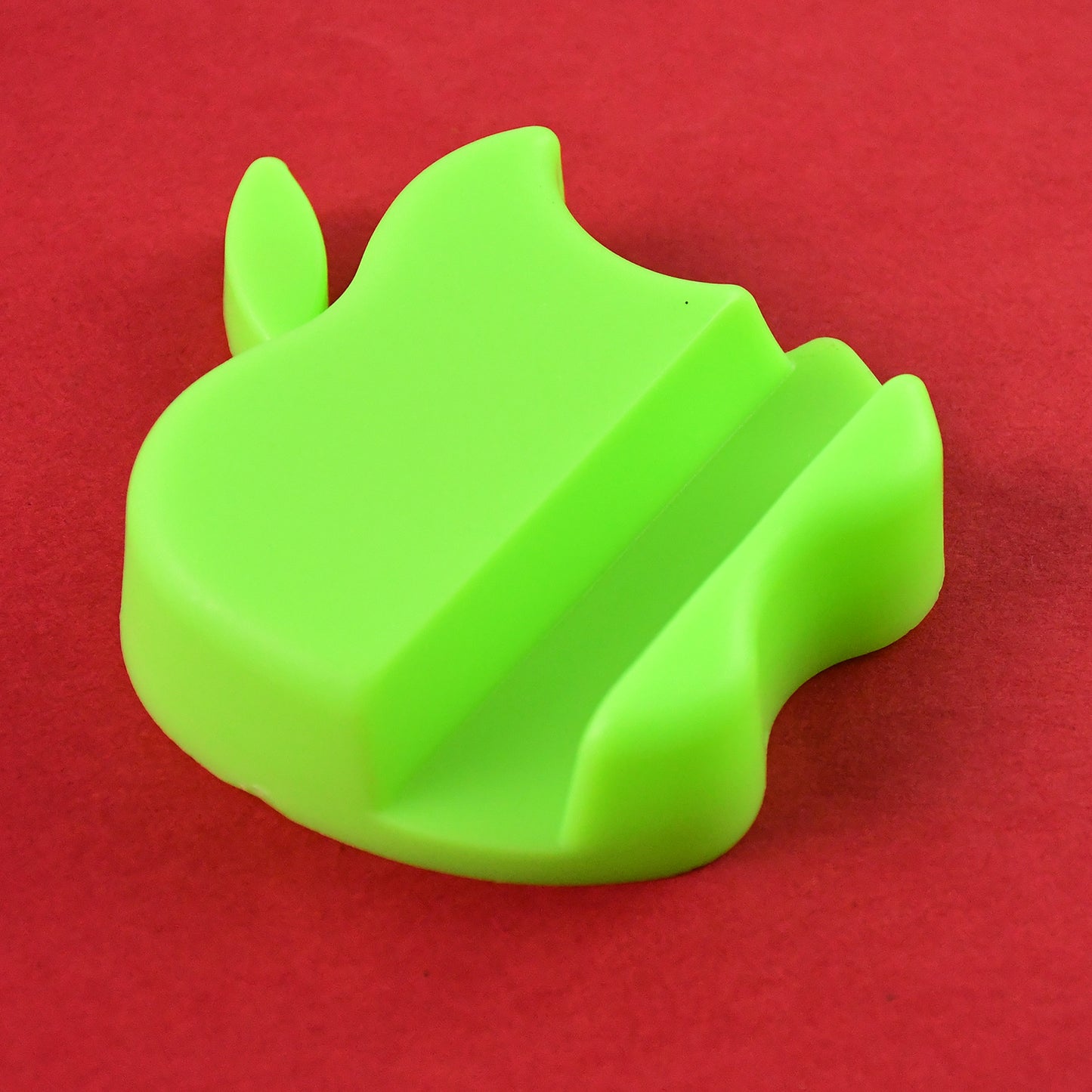 Set of three colorful apple-shaped plastic mobile phone holders from Wukusy, designed for secure phone support and display.