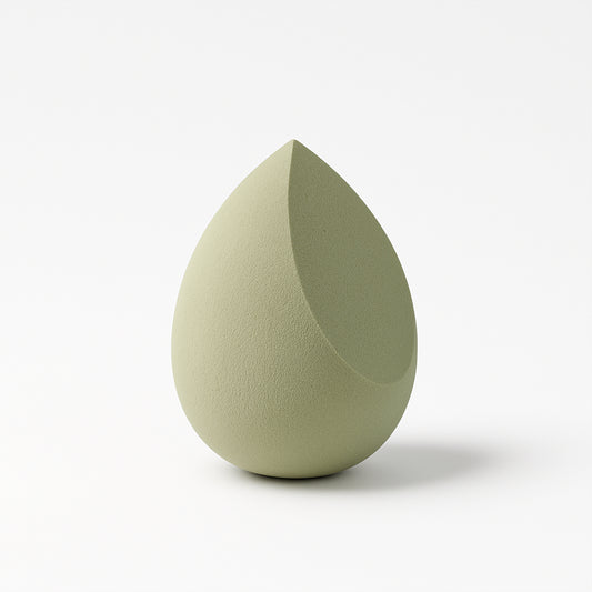 Multicolor Wukusy makeup sponge for blending liquid foundations, powders, and creams, shown in close-up on a white background.