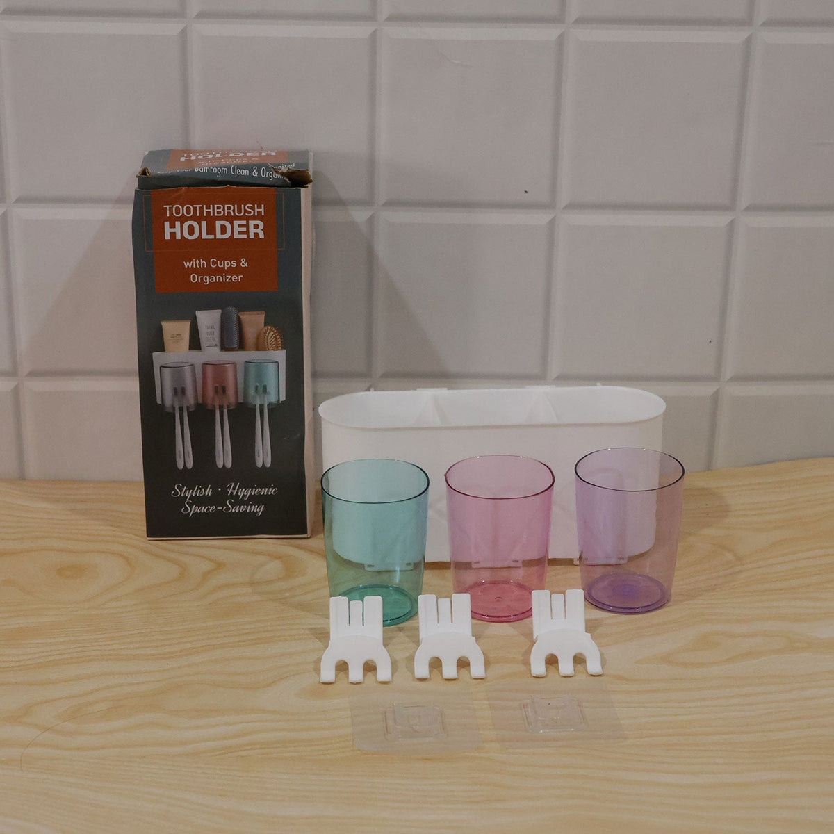 Wall-mounted Wukusy toothbrush holder with three cups and bathroom storage, shown with toothbrushes and toiletries.
