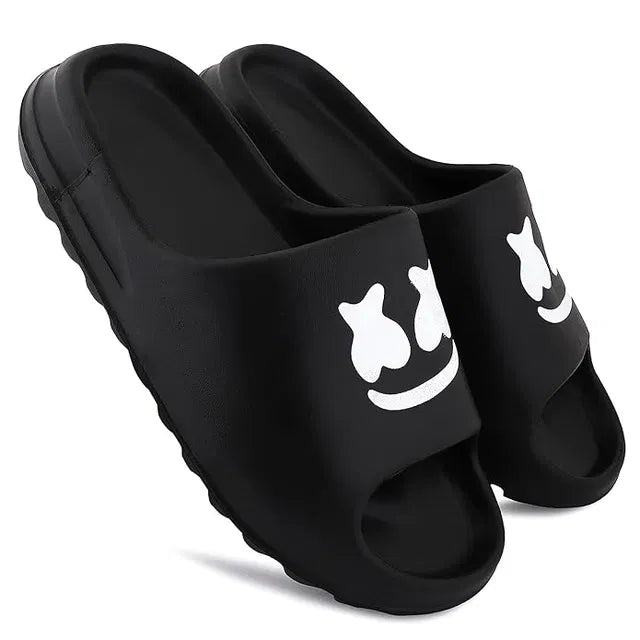 Black Smile Slides by 1765, stylish slippers with a comfortable slip-on design and smile detail on the black background.