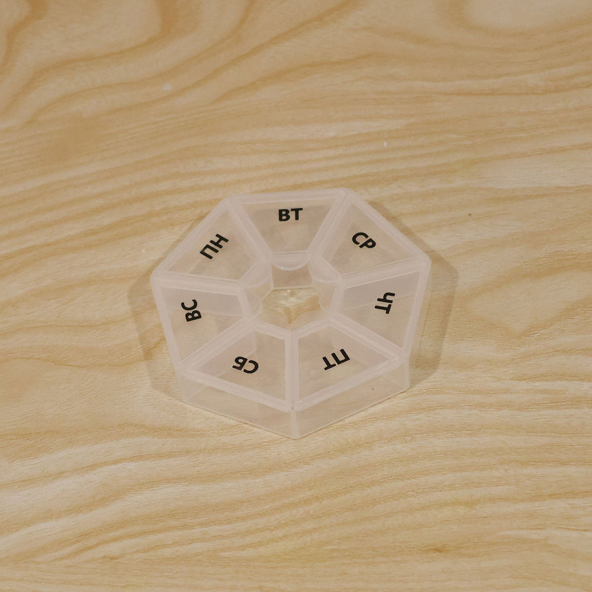Wukusy medicine pill box with 7 compartments and clear flip lids for weekly travel storage, compact and portable design.