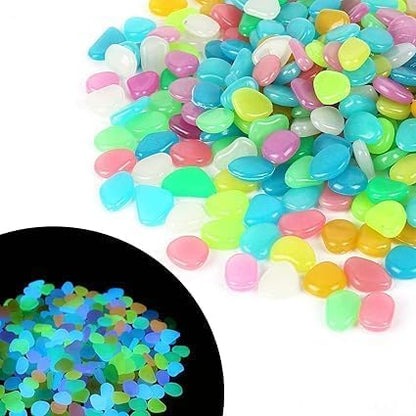 Glow in the Dark Rocks by Drpshippr, 100 luminous pebbles for garden, aquarium, pond, and outdoor decoration, glowing stones in a yard setting.