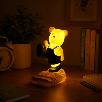 Wukusy magnetic bear LED light phone stand night lamp on desk, featuring a cute bear design for kids' rooms and night lighting.
