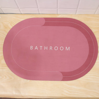 Two-tone oval bathroom rug by Wukusy, water-absorbing and anti-skid mat in beige and gray, 58.5x39 cm.