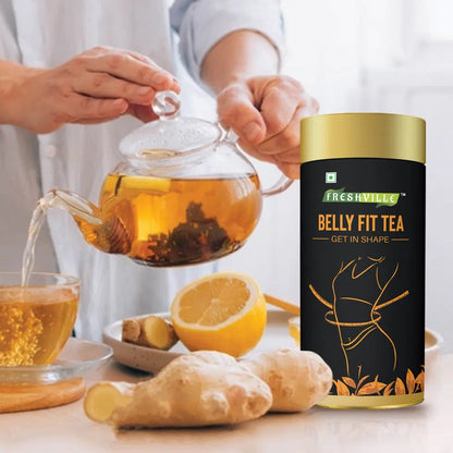 Freshville Belly Fit Tea in a clear glass tea pot, showing the brewed tea with fresh leaves and a modern design.
