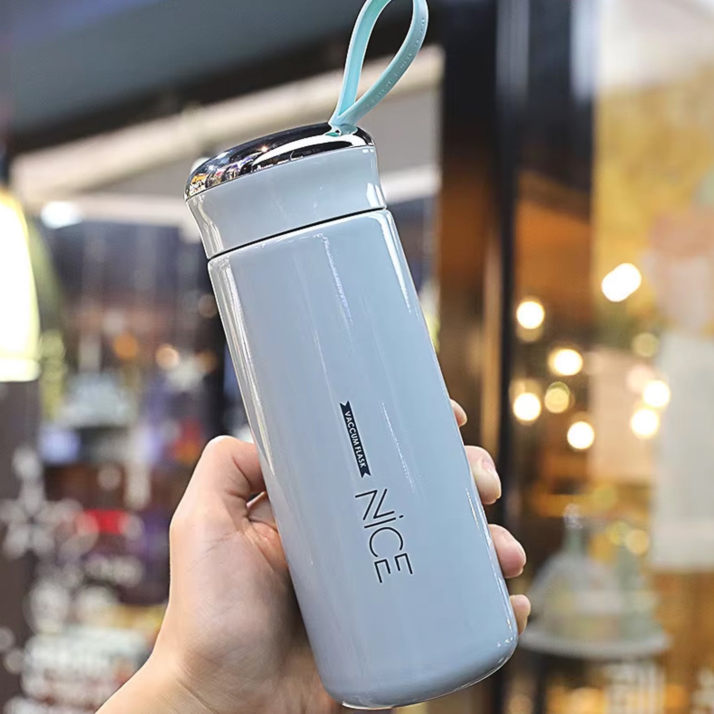 Light blue Wukusy 400ml leak-proof glass water bottle for gym and children, with daily water intake markings visible.
