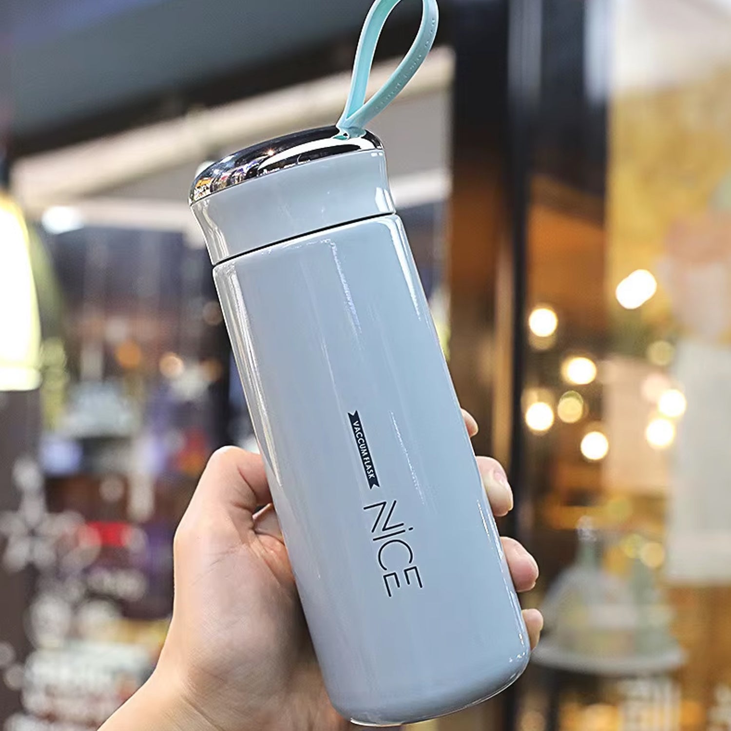 Light blue Wukusy 400ml leak-proof glass water bottle for gym and children, with daily water intake markings visible.