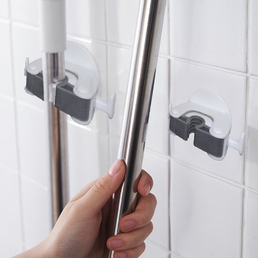 Wukusy 1670 Mop and Broom Holder mounted on wall, holding cleaning tools with hooks and secure clips.