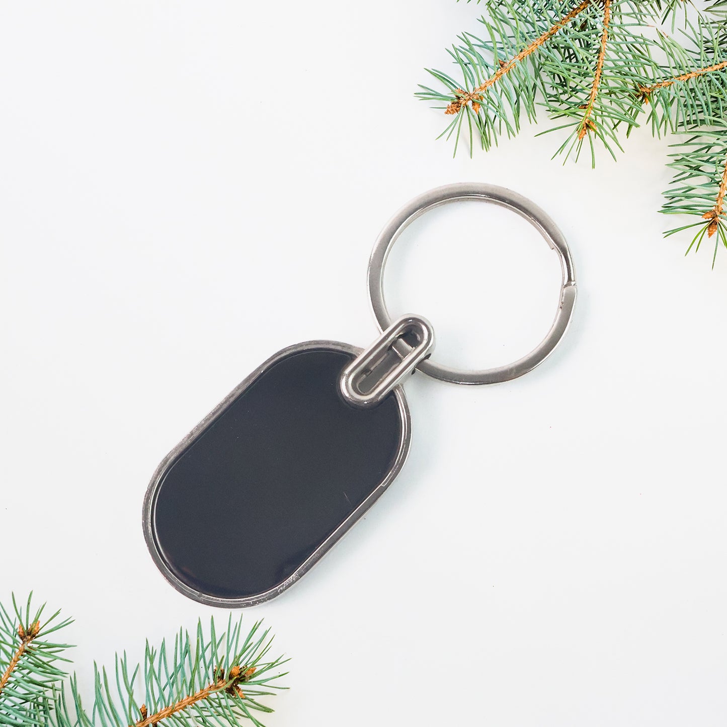 Elegant black and silver oval metal keychain by Wukusy featuring a sleek design and sturdy keyring.