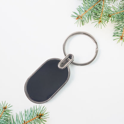 Elegant black and silver oval metal keychain by Wukusy featuring a sleek design and sturdy keyring.