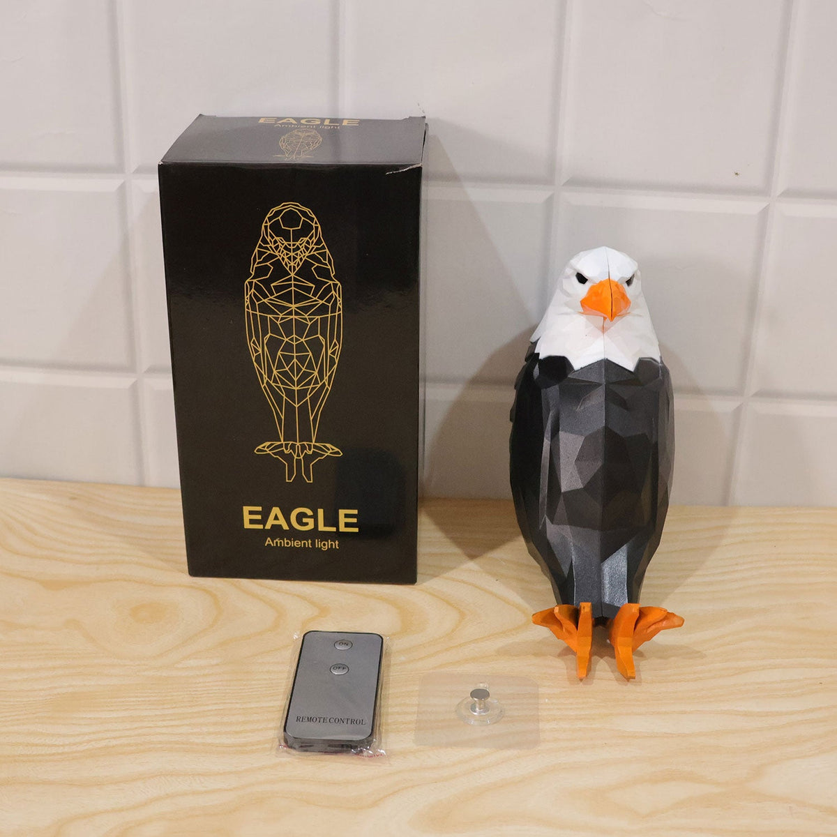 Wukusy eagle-shaped LED ambient wall light with remote and magnetic holder, mounted on wall, showcasing sleek design and lighting features.