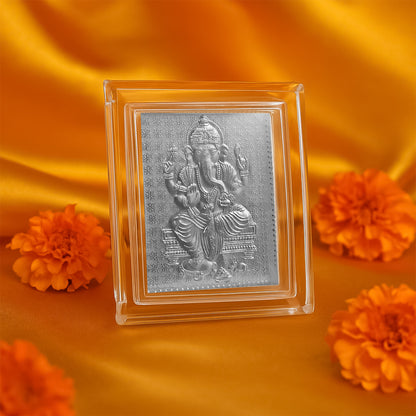 Silver-plated Lord Ganesha embossed photo frame, elegant home decor piece featuring detailed Ganesha design.