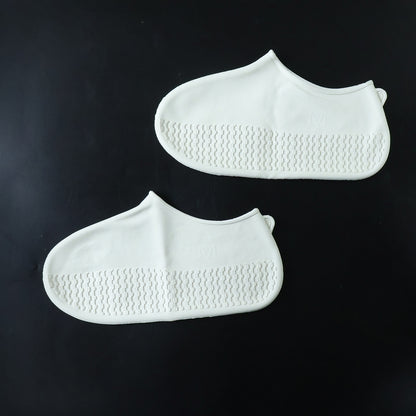 White waterproof silicone shoe covers by Wukusy, medium size, shown on a pair of shoes for protection against water and dirt.