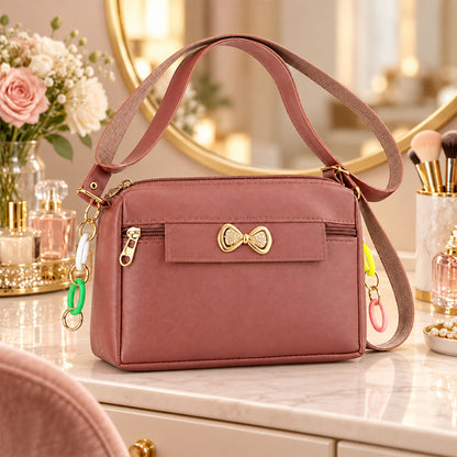 Wukusy women's PU leather sling bag with adjustable strap and bow, featuring a stylish design and compact size.