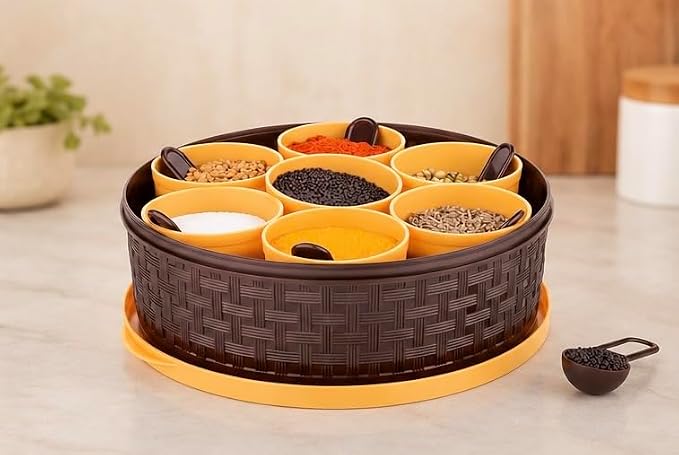 Dropdash plastic masala box with 7 compartments and spoons, used for storing spices in religious and spiritual kitchens.