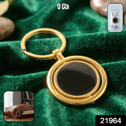 Gold plated keychain with black round rotating pendant and keyring, featuring the Wukusy brand logo on the pendant.