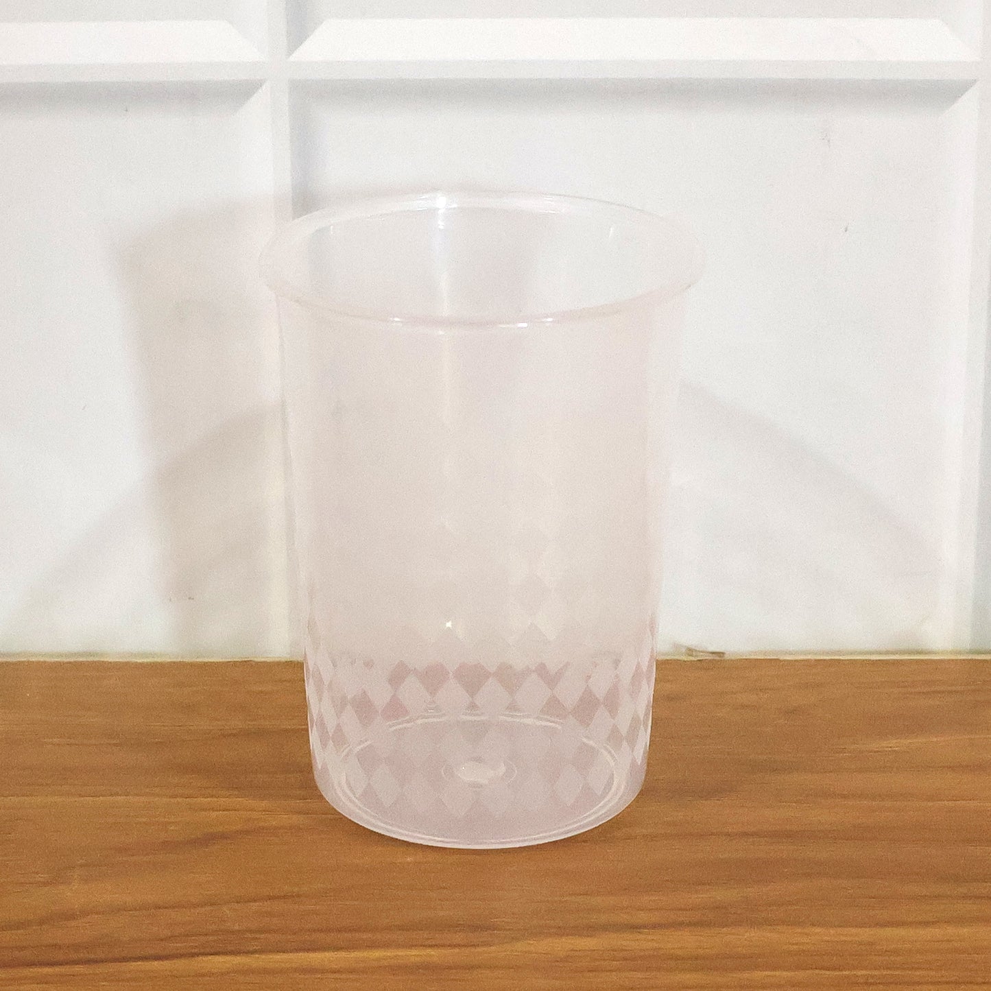 Clear reusable plastic drinking glass by Wukusy, 200 ml capacity, shown with a transparent design and smooth surface.