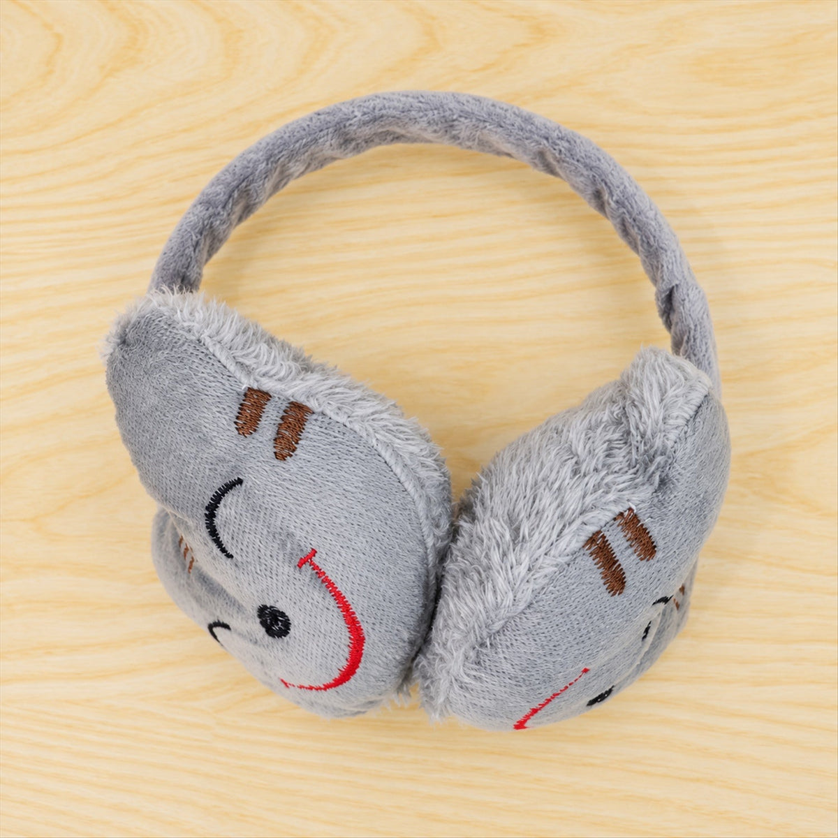 Wukusy smiley plush winter ear muffs for cold weather, soft, warm, and cozy ear coverage for everyday winter wear.
