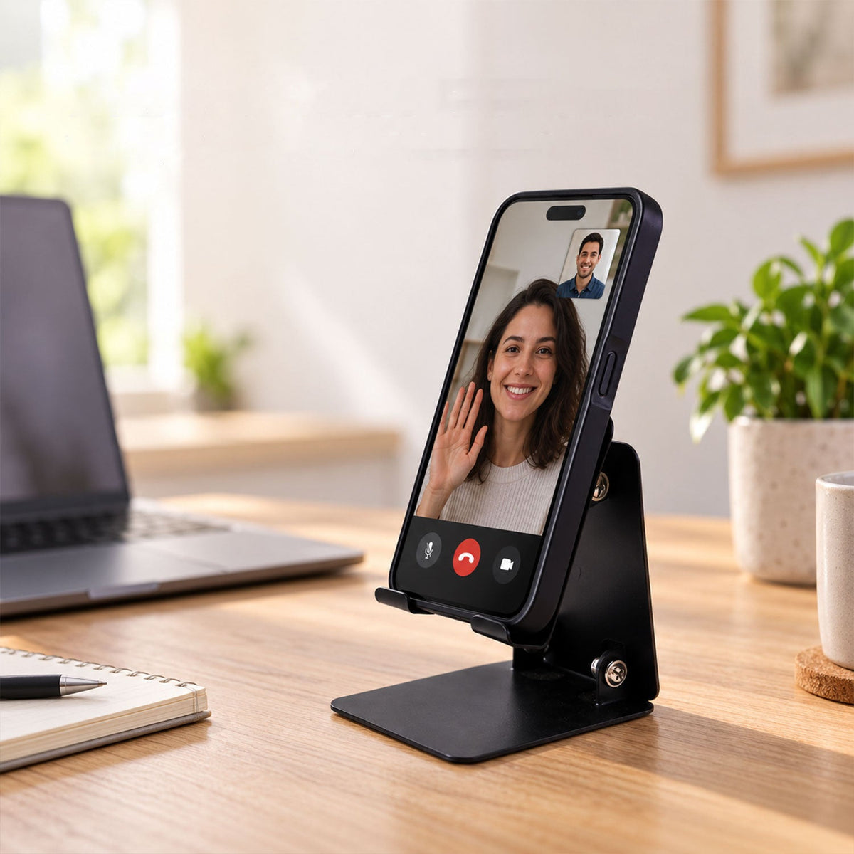 Wukusy foldable metal mobile phone stand with adjustable angle for desk use, shown holding a smartphone in a professional setting.