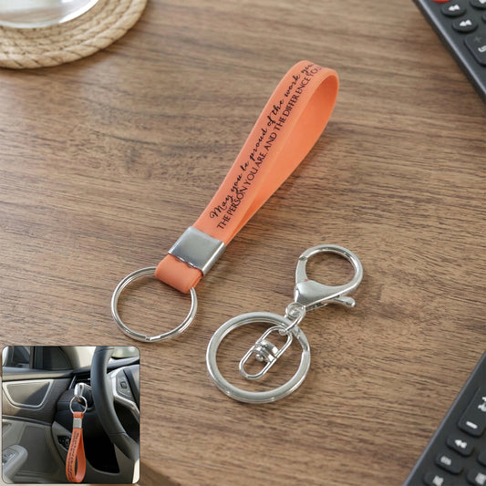 Two Wukusy silicone wrist strap keychains with metal key rings, shown with colorful silicone bands and sturdy hooks.