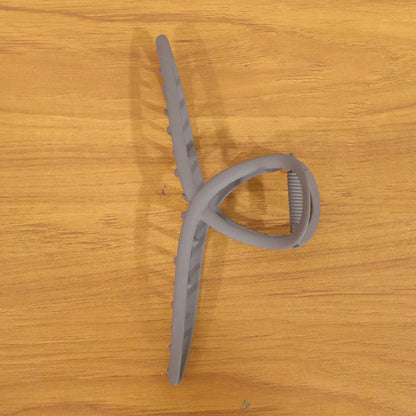 Large Wukusy strong grip hair claw clip holding thick hair, showcasing its sturdy design and wide opening.