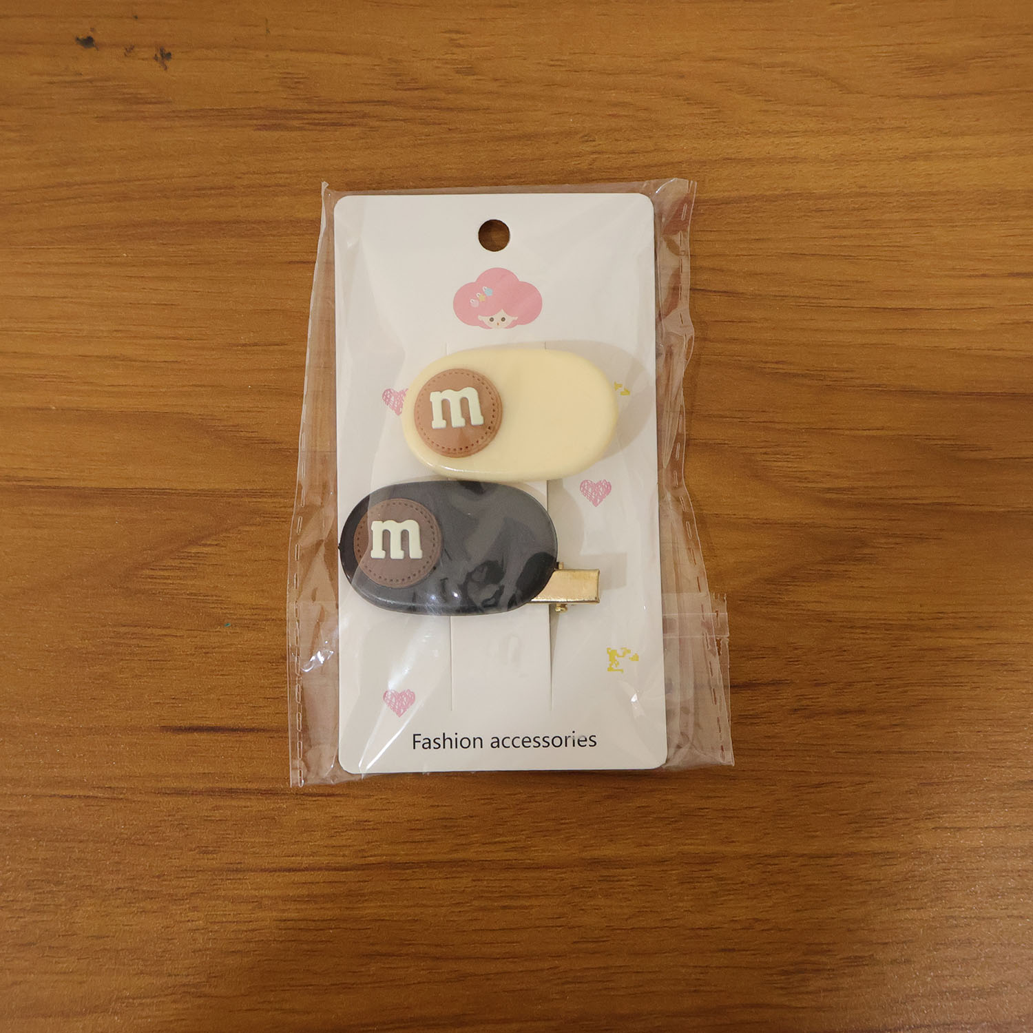 Set of two Wukusy alphabet letter design decorative hair clips with colorful, playful letter embellishments on metal clips.