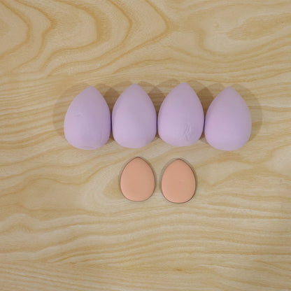 Wukusy makeup blending sponge and powder puff set for face cosmetics, showing six soft applicators and puff in a compact layout.