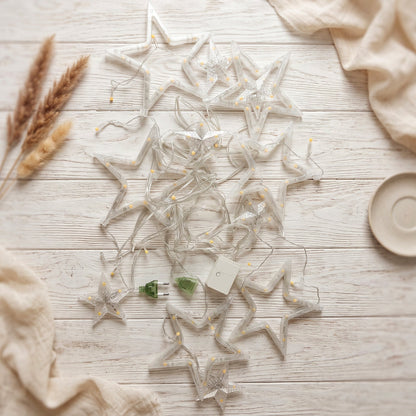 White star LED string lights by Wukusy, warm fairy lights for decoration, displayed hanging with glowing stars in the image.