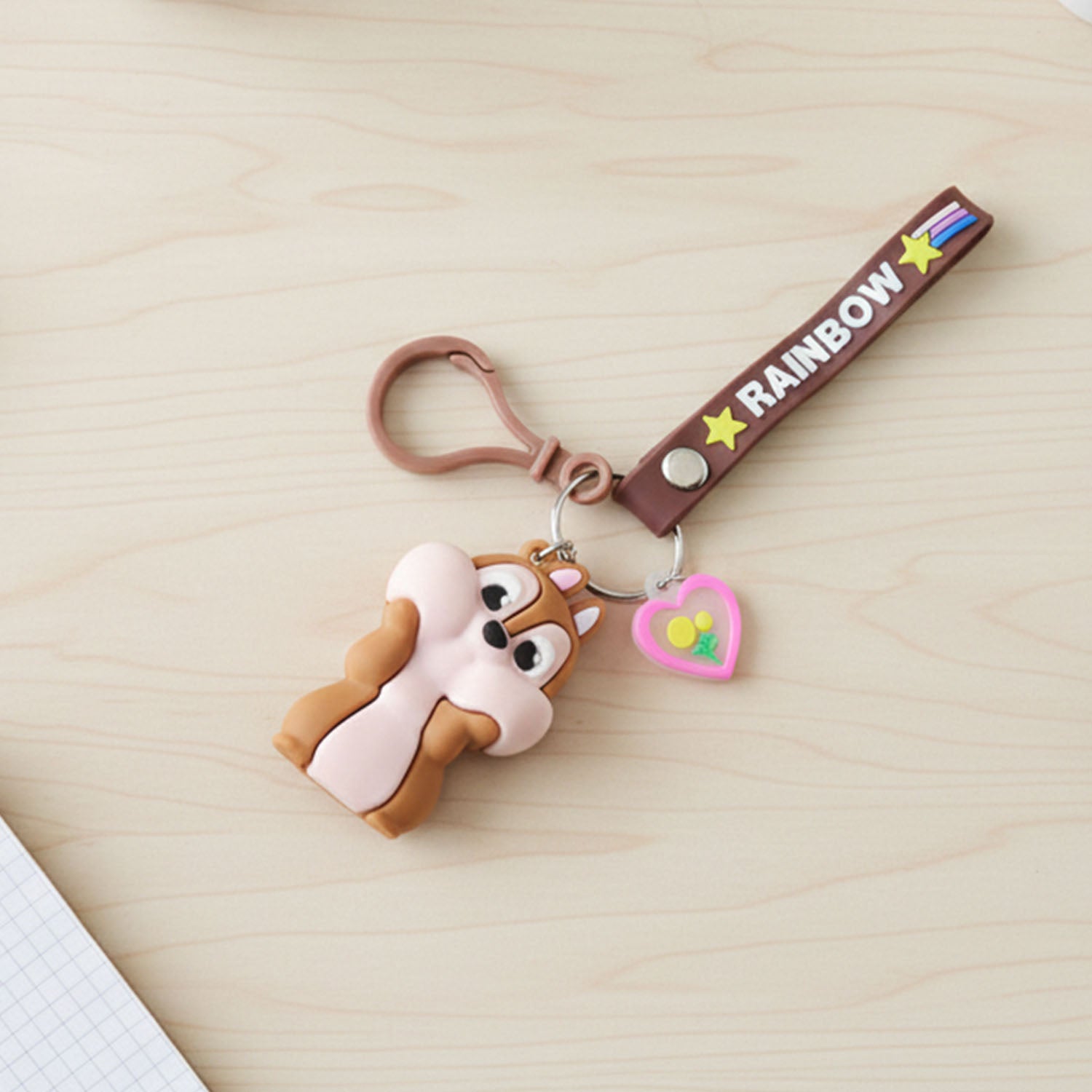 Cute cartoon animal silicone keychain with rainbow strap by Wukusy, featuring colorful animal design on a vibrant strap.
