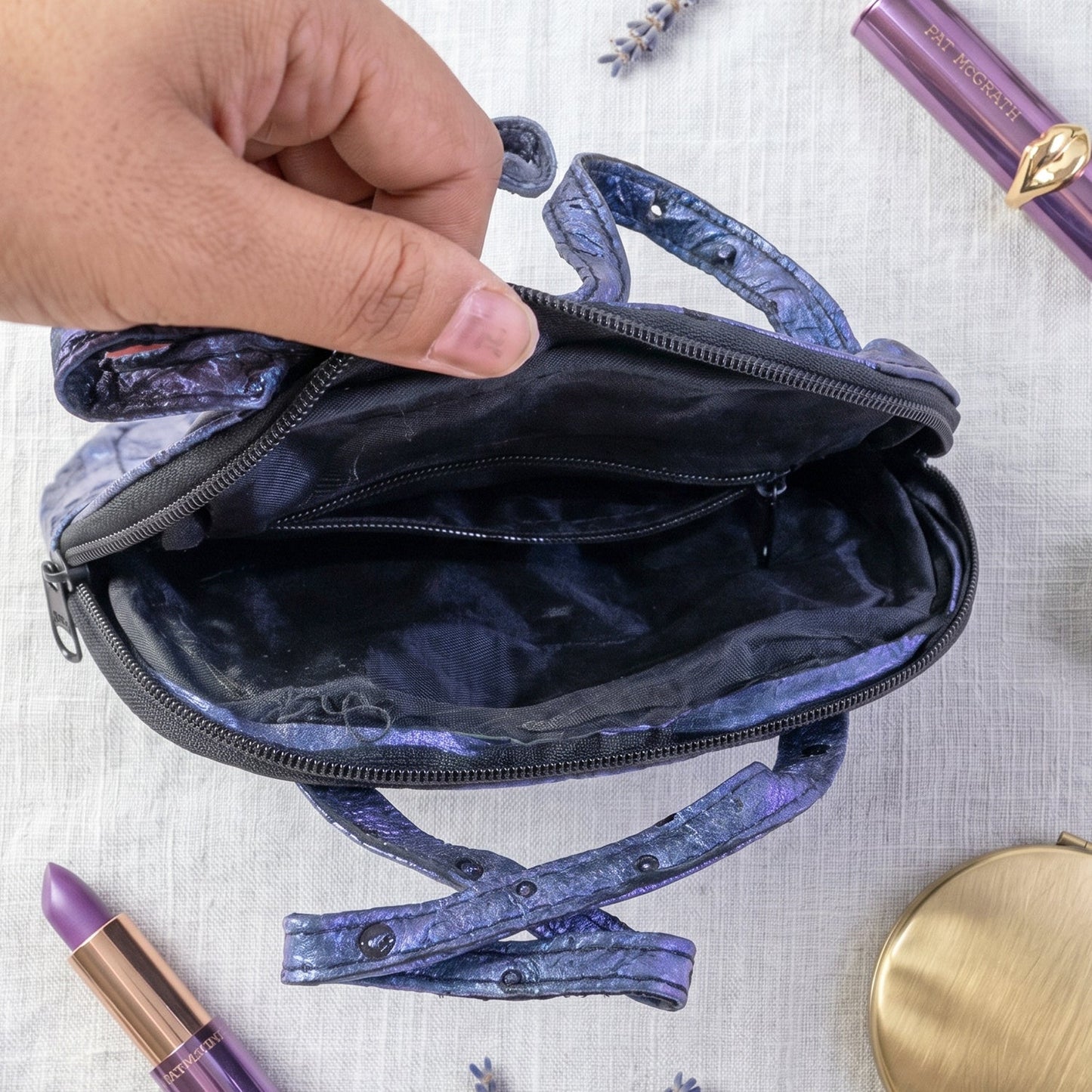 Metallic blue mini zipper handbag with ostrich pattern for women by Wukusy, featuring a stylish, textured leather design.