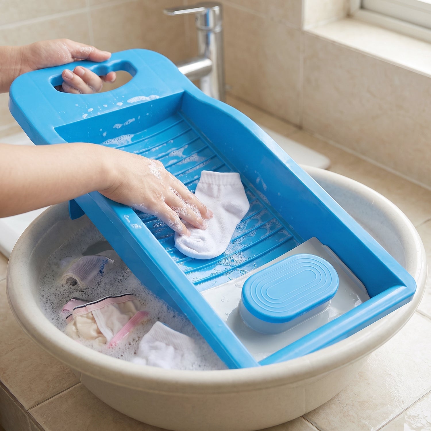 Portable plastic mini washing board with soap holder for laundry, ideal for washing socks and small clothing items by Wukusy.
