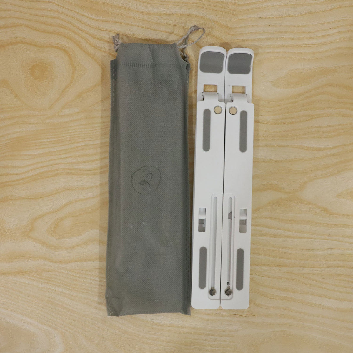 Wukusy portable foldable laptop stand with adjustable height and angle, supporting ergonomic workspace setup.