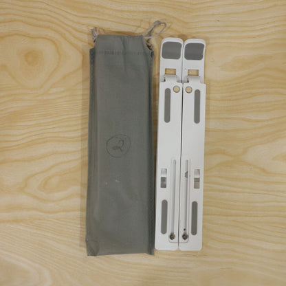 Wukusy portable foldable laptop stand with adjustable height and angle, supporting ergonomic workspace setup.